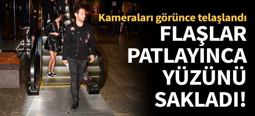 Flaşlar patlayınca yüzünü sakladı!
