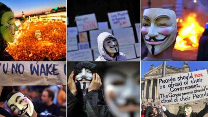 İngiltere'de maskeli protestocular başbakanın kuklalarını yaktı!